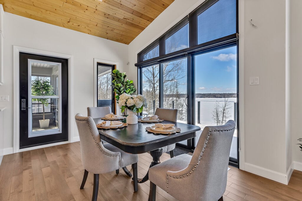 dining area with large window overlooking lake